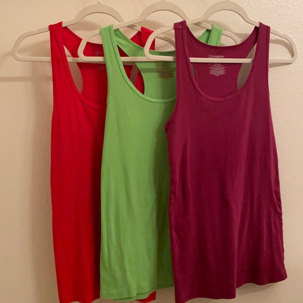 Different color tank tops red green and purple